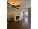 Bright living room featuring hardwood floors, fireplace, and ceiling fan at 124 Streamside Dr # 24, Roswell, GA 30076