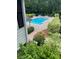 Beautiful community pool offering a refreshing escape amidst serene landscaping and mature trees at 124 Streamside Dr # 24, Roswell, GA 30076