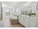 Bright bathroom with a large tub, shower, and vanity with granite countertops at 2207 Derbyshire Sw Dr, Marietta, GA 30064