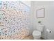 Neat bathroom with a polka dot shower curtain, toilet, and wall art creating a charming space at 2207 Derbyshire Sw Dr, Marietta, GA 30064