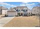 Charming two-story home with a manicured front yard, attached garage, and classic architectural details at 2207 Derbyshire Sw Dr, Marietta, GA 30064