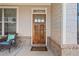 Close up of front door, rocking chair and welcome mat on a charming front porch at 2207 Derbyshire Sw Dr, Marietta, GA 30064