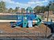 Community playground with a slide, climbing wall and steps located next to the tennis courts at 2207 Derbyshire Sw Dr, Marietta, GA 30064