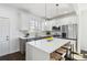 Modern kitchen features a large kitchen island with seating, pendant lighting, and stainless steel appliances at 2395 Saint James Nw Dr, Atlanta, GA 30318