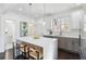 Spacious kitchen island features pendant lighting, hardwood floors, stainless appliances, and island seating at 2395 Saint James Nw Dr, Atlanta, GA 30318