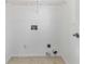 Bright laundry room featuring tiled floor and white walls with all necessary hookups at 2395 Saint James Nw Dr, Atlanta, GA 30318