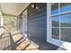 Covered porch with wooden decking, dark siding, and lots of natural light at 2395 Saint James Nw Dr, Atlanta, GA 30318