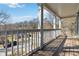 View of the wood porch with white railings showing neighborhood views on a sunny day at 2395 Saint James Nw Dr, Atlanta, GA 30318