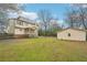 Exterior view of a home with a spacious backyard and a storage shed at 381 Gates Mil Dr, Lawrenceville, GA 30045