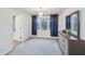 Bedroom featuring neutral walls, plush carpet, dresser, curtains, and natural light at 381 Gates Mil Dr, Lawrenceville, GA 30045