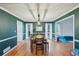 Dining room with green walls, wood table and bench and modern light fixture at 381 Gates Mil Dr, Lawrenceville, GA 30045