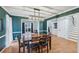 Inviting dining room featuring hardwood floors, green walls, and modern lighting fixture, perfect for Gathering gatherings at 381 Gates Mil Dr, Lawrenceville, GA 30045