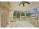 Covered porch boasts views of the backyard and a ceiling fan at 381 Gates Mil Dr, Lawrenceville, GA 30045