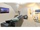 Spacious basement featuring a media area with television and a workout area with exercise equipment at 203 Lenox Dr, Peachtree City, GA 30269