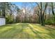 Large grassy backyard with mature trees, offering a serene outdoor space at 2122 Kimberly Sw Rd, Atlanta, GA 30331