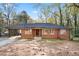 Charming single-story brick home featuring a screened porch and a well-maintained yard with mature trees at 2122 Kimberly Sw Rd, Atlanta, GA 30331