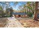 View of the front of the home from the driveway, showcasing its classic brick facade at 2122 Kimberly Sw Rd, Atlanta, GA 30331