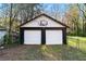 Two-car garage with white doors and a basketball hoop on a grassy lawn at 2122 Kimberly Sw Rd, Atlanta, GA 30331