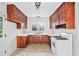 Traditional-style kitchen features warm wood cabinets, white countertops, and a window over the sink at 2122 Kimberly Sw Rd, Atlanta, GA 30331
