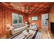 Cozy living room with wood paneling, checker ceiling, with natural light, and contemporary furnishings at 2122 Kimberly Sw Rd, Atlanta, GA 30331