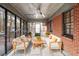 Relaxing screened porch with brick siding, neutral furniture, and a ceiling fan at 2122 Kimberly Sw Rd, Atlanta, GA 30331