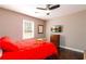 Cozy bedroom with red bedding, ceiling fan, and television at 3224 Canary Ct, Decatur, GA 30032