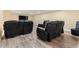 Basement featuring a large seating area with black leather recliners and wood floors at 3710 Glen Ian Dr, Loganville, GA 30052