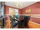 Formal dining room with hardwood floors, stylish furnishings, and ample natural light at 3710 Glen Ian Dr, Loganville, GA 30052