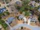 Aerial view of home and neighborhood featuring mature trees and a pond at 1320 Kildare Ct, Snellville, GA 30078