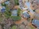 Aerial view of home, surrounded by mature trees and a pond at 1320 Kildare Ct, Snellville, GA 30078