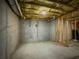 Unfinished basement showing concrete walls and floor, with exposed wooden framing at 1320 Kildare Ct, Snellville, GA 30078