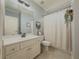 Charming bathroom featuring a vanity with framed mirror, neutral walls, and decorative curtain at 1320 Kildare Ct, Snellville, GA 30078