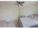 Inviting bedroom with a wrought iron bed, light-colored walls, ceiling fan, and dual closets at 1320 Kildare Ct, Snellville, GA 30078