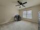 Bright bedroom with carpet, featuring a ceiling fan, window, and study desk setup at 1320 Kildare Ct, Snellville, GA 30078