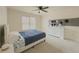 Bright bedroom with a bed, ceiling fan, and closet, offering a peaceful retreat at 1320 Kildare Ct, Snellville, GA 30078