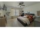 Cozy bedroom with a ceiling fan, large window, and carpeted floor, promoting relaxation at 1320 Kildare Ct, Snellville, GA 30078