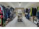 Spacious walk-in closet with custom shelving, hanging rods, and a dedicated shoe display at 1320 Kildare Ct, Snellville, GA 30078
