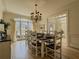 Formal dining room features large windows, hardwood floors, and elegant chandelier at 1320 Kildare Ct, Snellville, GA 30078