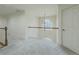 Well-lit hallway with carpet, white railing overlooking lower level, and chandelier at 1320 Kildare Ct, Snellville, GA 30078