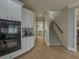 Well-lit kitchen adjacent to stairs, showcasing hardwood floors, white cabinets, and modern built-in appliances at 1320 Kildare Ct, Snellville, GA 30078