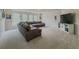 Spacious living room featuring a large sectional sofa, neutral carpet, and plenty of natural light at 1320 Kildare Ct, Snellville, GA 30078