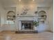 Close up of the living room fireplace with custom built-ins on either side at 1320 Kildare Ct, Snellville, GA 30078