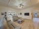 Spacious living room featuring hardwood floors, tray ceilings, and a seamless flow to the kitchen at 1320 Kildare Ct, Snellville, GA 30078