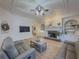 Bright living room featuring hardwood floors, a coffered ceiling, and a cozy fireplace at 1320 Kildare Ct, Snellville, GA 30078