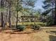 Close up of backyard pergola swing with landscaping, and pond at 1320 Kildare Ct, Snellville, GA 30078