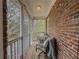 Cozy screened-in porch with brick siding, outdoor seating, and views of lush trees at 1320 Kildare Ct, Snellville, GA 30078