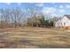 Large backyard space with mature trees and lush greenery provides a sense of privacy at 2148 Ne Indian Shoals Dr, Loganville, GA 30052