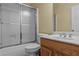 Bathroom with frosted glass shower doors, a toilet, and a vanity with brushed nickel hardware at 2148 Ne Indian Shoals Dr, Loganville, GA 30052
