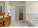 Bathroom featuring a soaking tub with tile surround and a closet at 2148 Ne Indian Shoals Dr, Loganville, GA 30052