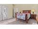 Bedroom features a door to the balcony and plenty of natural light at 2148 Ne Indian Shoals Dr, Loganville, GA 30052